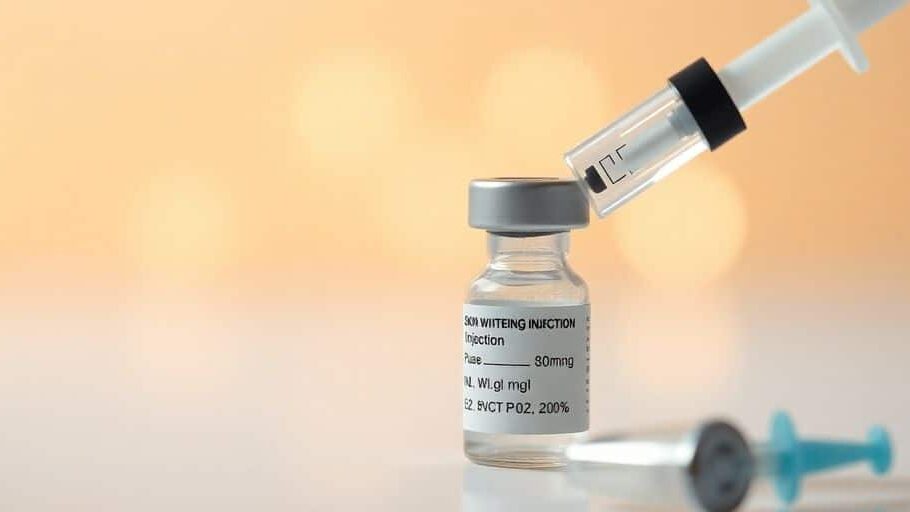 Skin whitening injection preparation with syringe and vials.